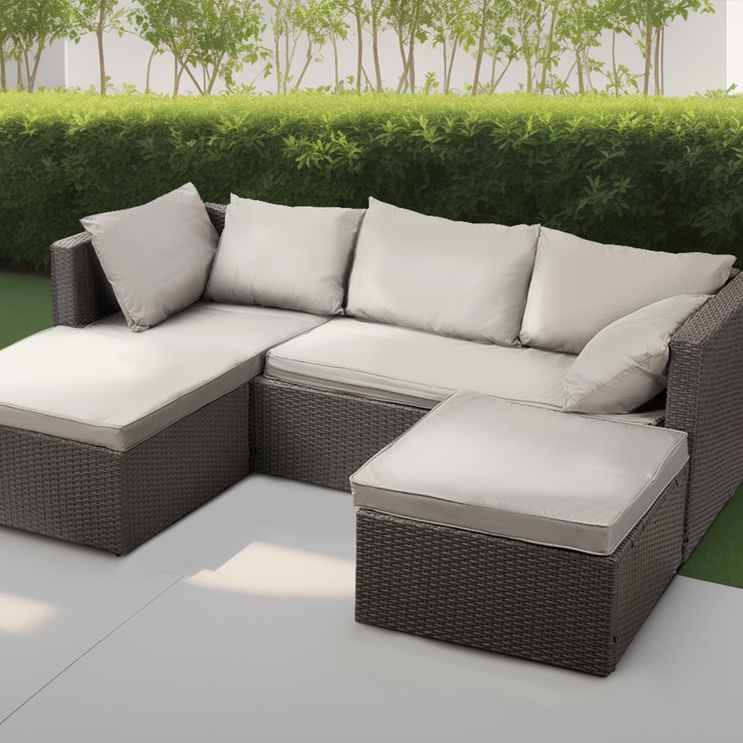 Grey rattan sectional sofa with cream cushions for garden furniture